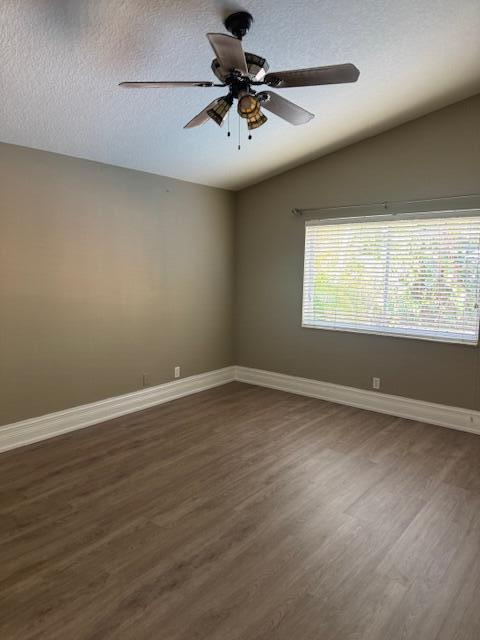 2420 Southeast Springtree Place Stuart, FL 34997 - Photo 11 of 18 wooden floor in an empty room with a window