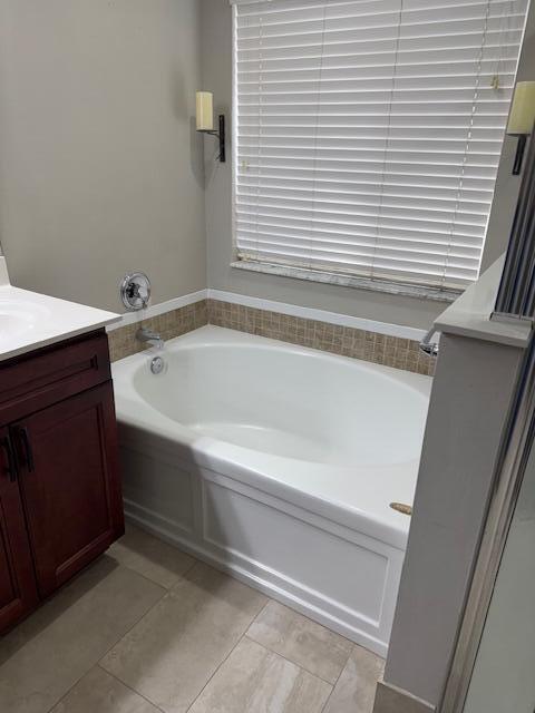 2420 Southeast Springtree Place Stuart, FL 34997 - Photo 13 of 18 a bathroom with a bathtub and a sink