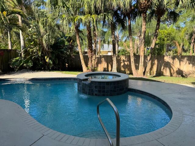 2420 Southeast Springtree Place Stuart, FL 34997 - Photo 15 of 18 a view of swimming pool with a yard