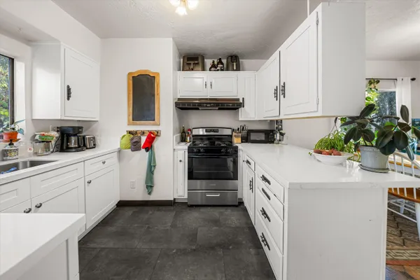 a kitchen with a sink stove and cabinets
