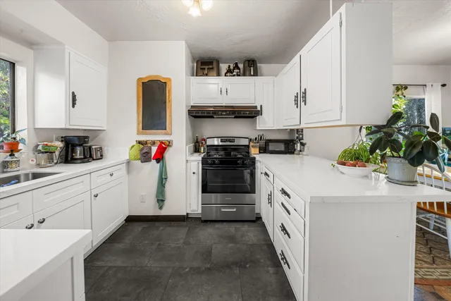 a kitchen with a sink stove and cabinets