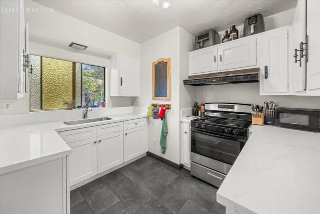 a kitchen with stainless steel appliances and white cabinets