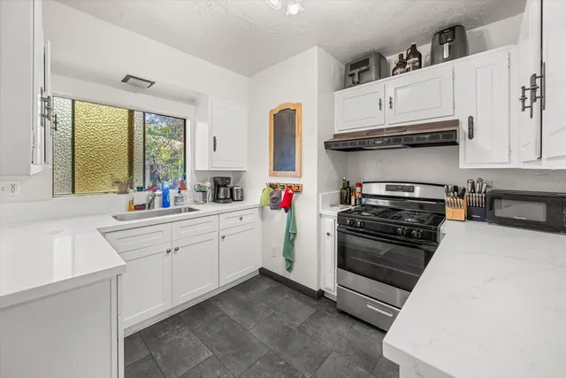 a kitchen with stainless steel appliances and white cabinets