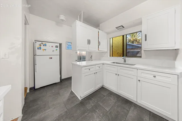 a kitchen with white cabinets and white appliances