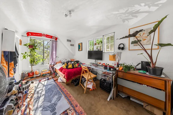 a bedroom with furniture and a flat screen tv