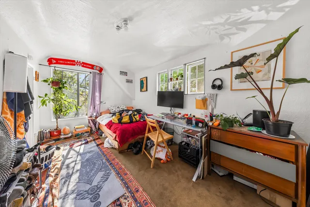 a bedroom with furniture and a flat screen tv