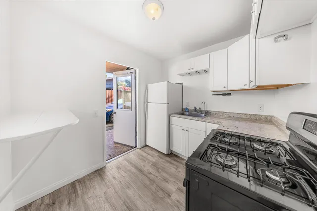 a kitchen with a stove a refrigerator and a sink