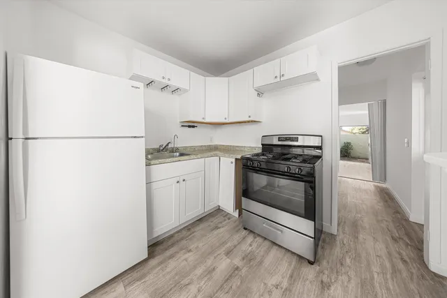 a kitchen with a white cabinets and white appliances