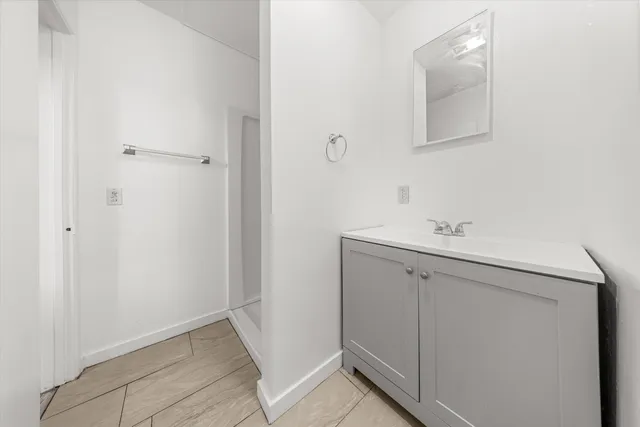 a bathroom with a sink and mirror