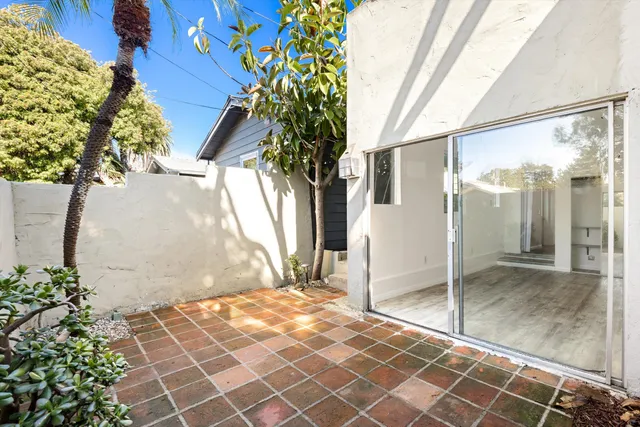 a bathroom with a glass door shower and a sink