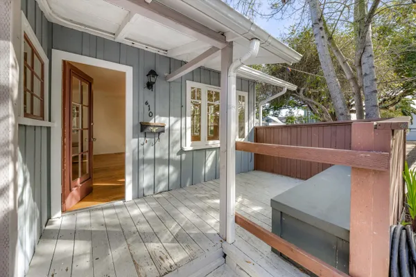 a view of a house with a large window and wooden floor