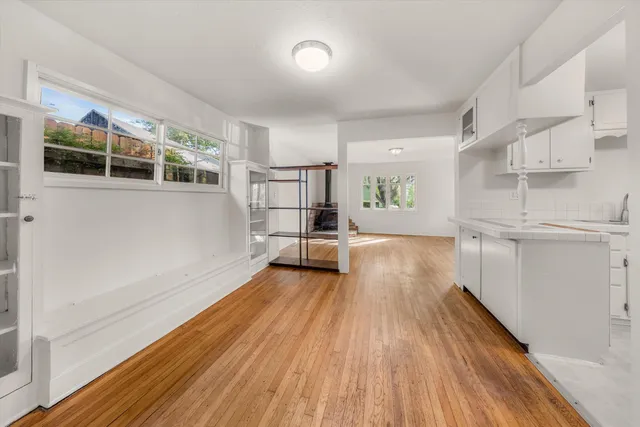 a view of empty room with wooden floor