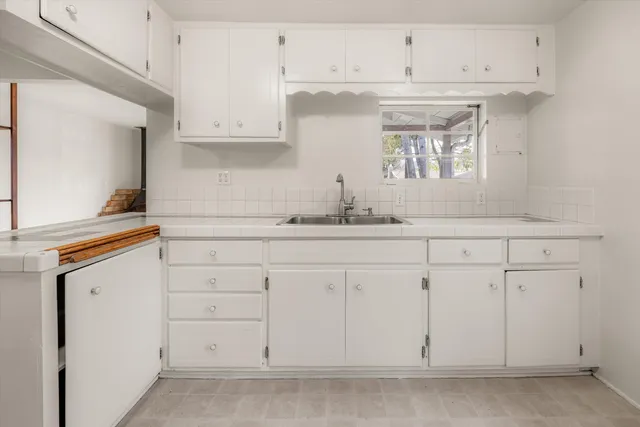 a kitchen with cabinets and window
