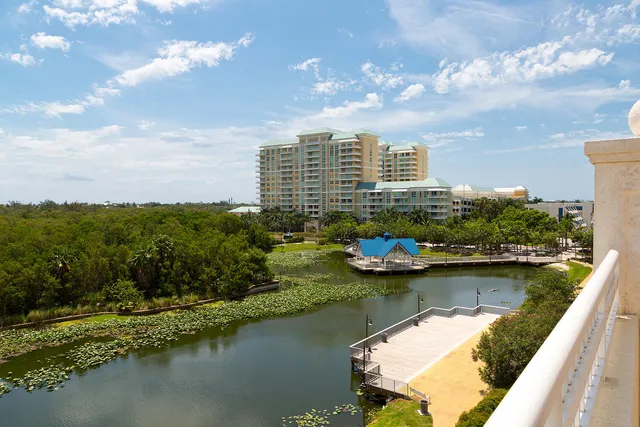 a view of a lake with houses in back