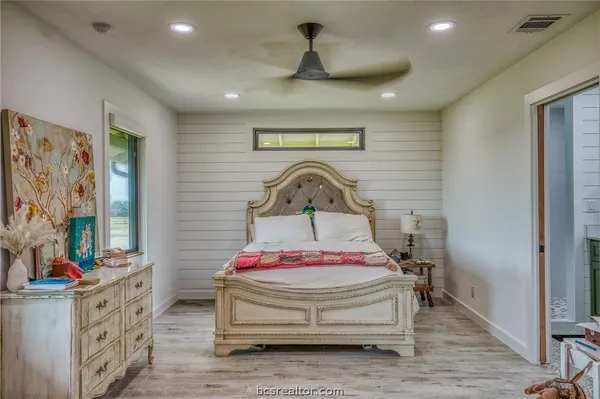 a bedroom with a bed and a dresser