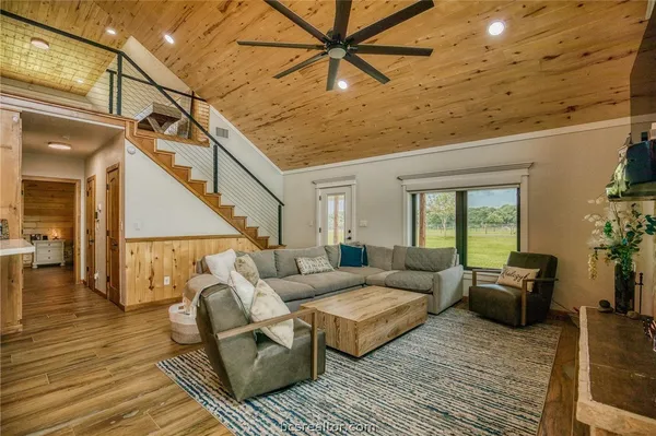 a living room with furniture and wooden floor
