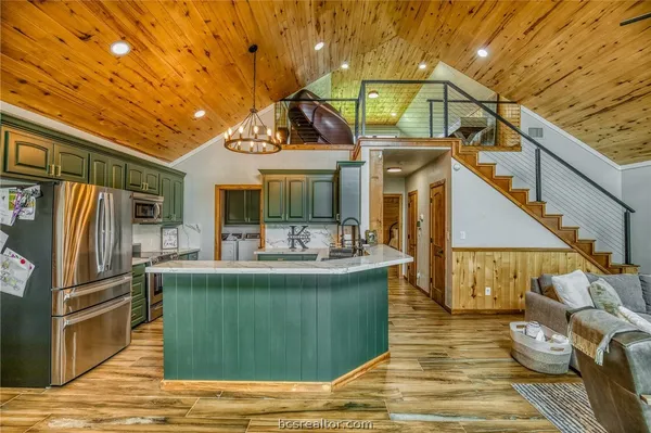 a view of a kitchen with furniture and wooden floor