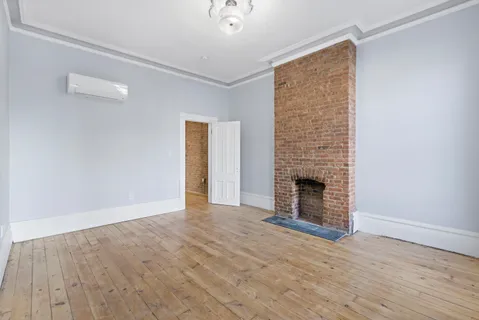 a view of empty room with a fireplace