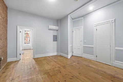 a view of empty room with wooden floor