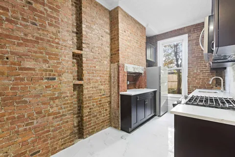 a spacious bathroom with a granite countertop sink a mirror and shower