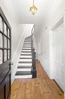 a view of entryway and hall with wooden floor