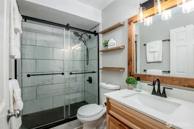 a bathroom with a sink toilet and shower