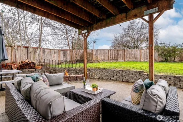 a view of a house with a yard and sitting area