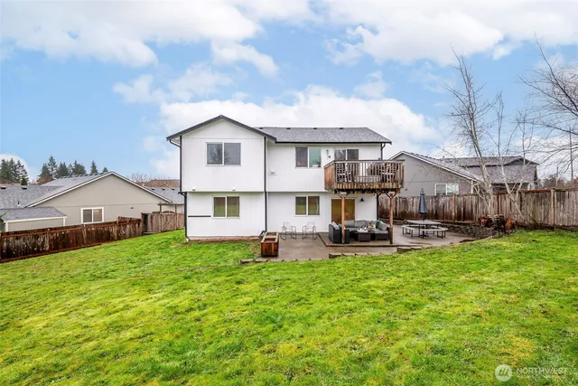 a view of a house with a big yard and large trees