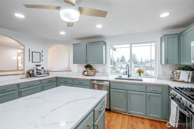 a kitchen with a sink stove and cabinets