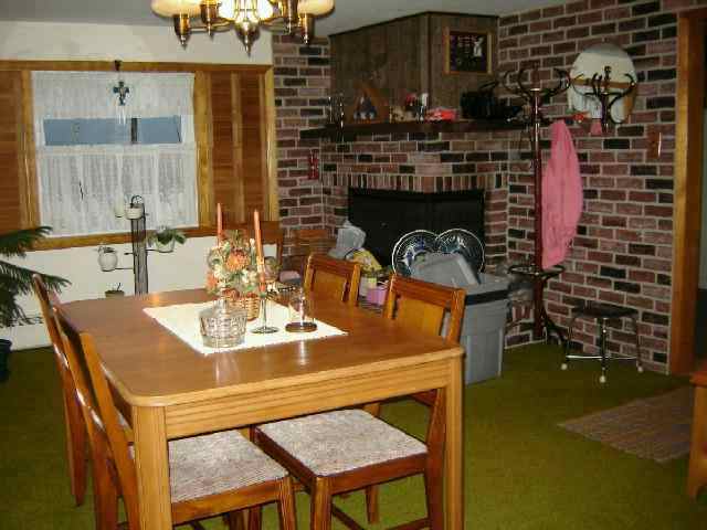 5138 Oakville Road Chadwick, IL 61014 - Photo 8 of 9 a kitchen with a table chairs and a stove
