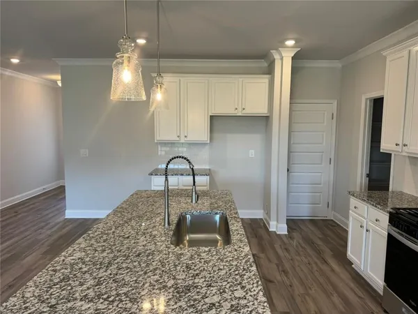 a kitchen with a sink microwave and stove