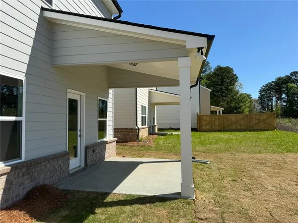 a view of a patio with table and chairs with wooden floor and fence