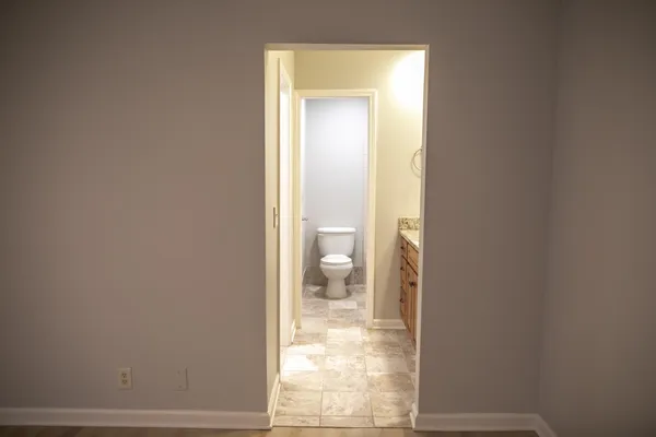a view of a bathroom from a corridor