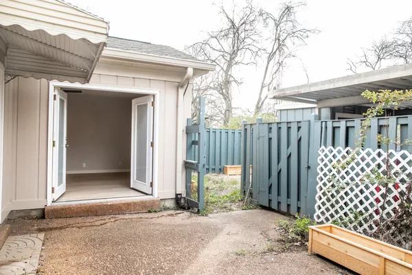 a backyard of a house with a small yard and wooden fence