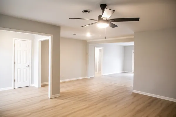 a view of an empty room and wooden floor