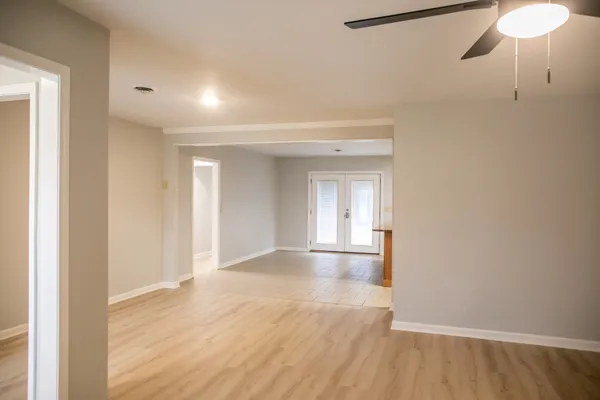 a view of empty room with wooden floor