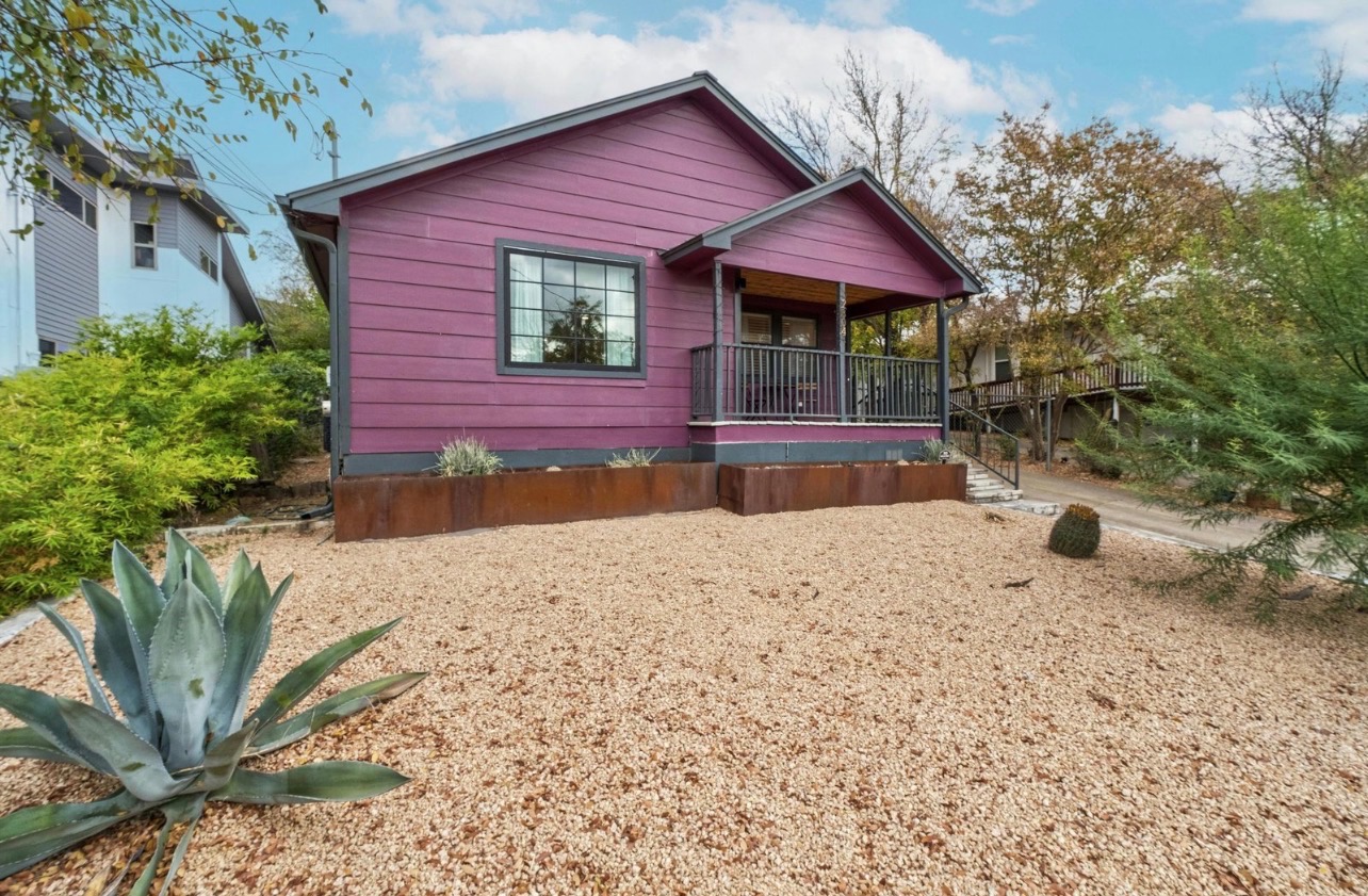 a view of a backyard with a barbeque grill and a yard