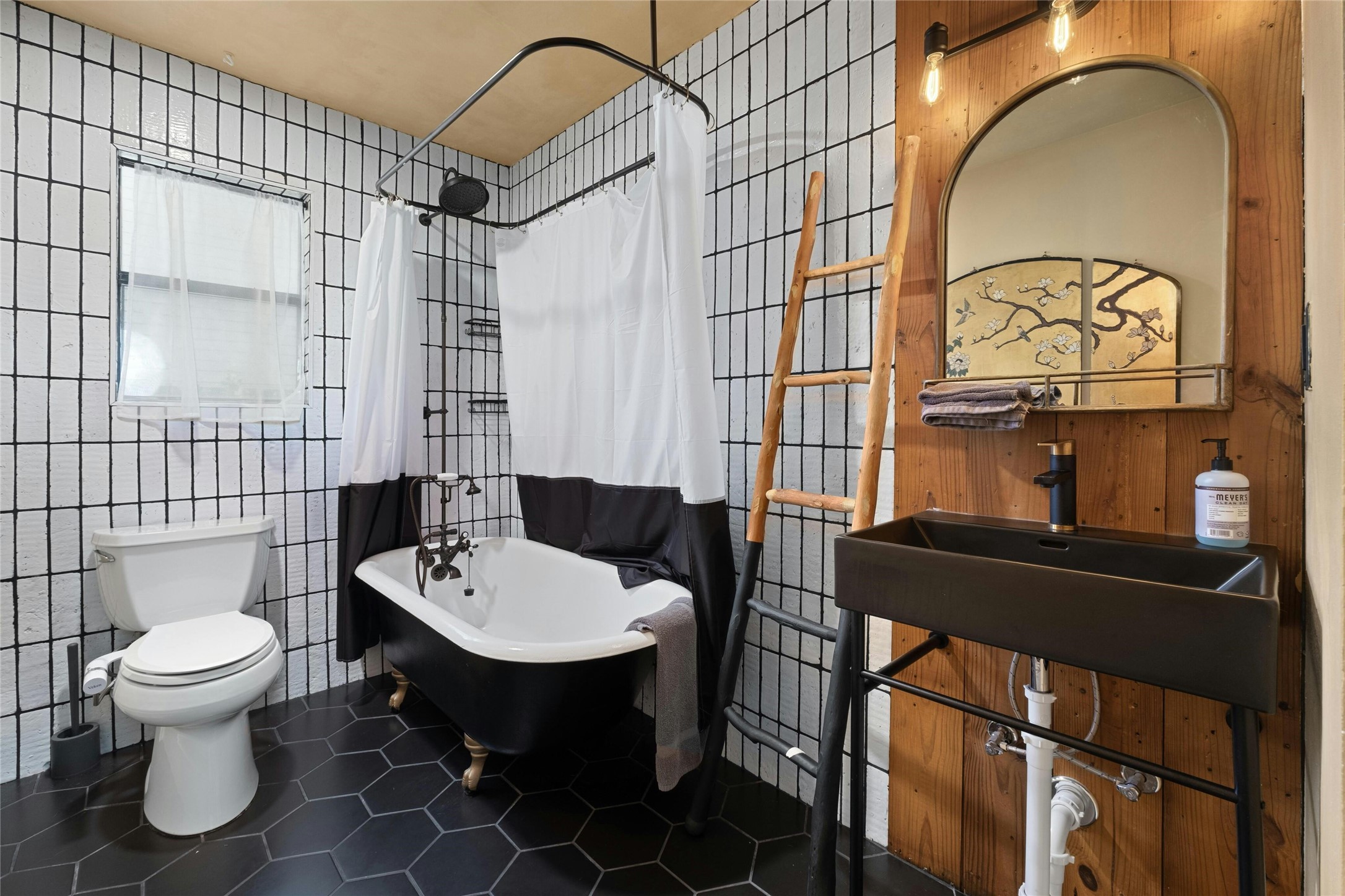 2804 Crest Avenue Austin, TX 78702 - Photo 12 of 16 a bathroom with a sink a toilet and mirror