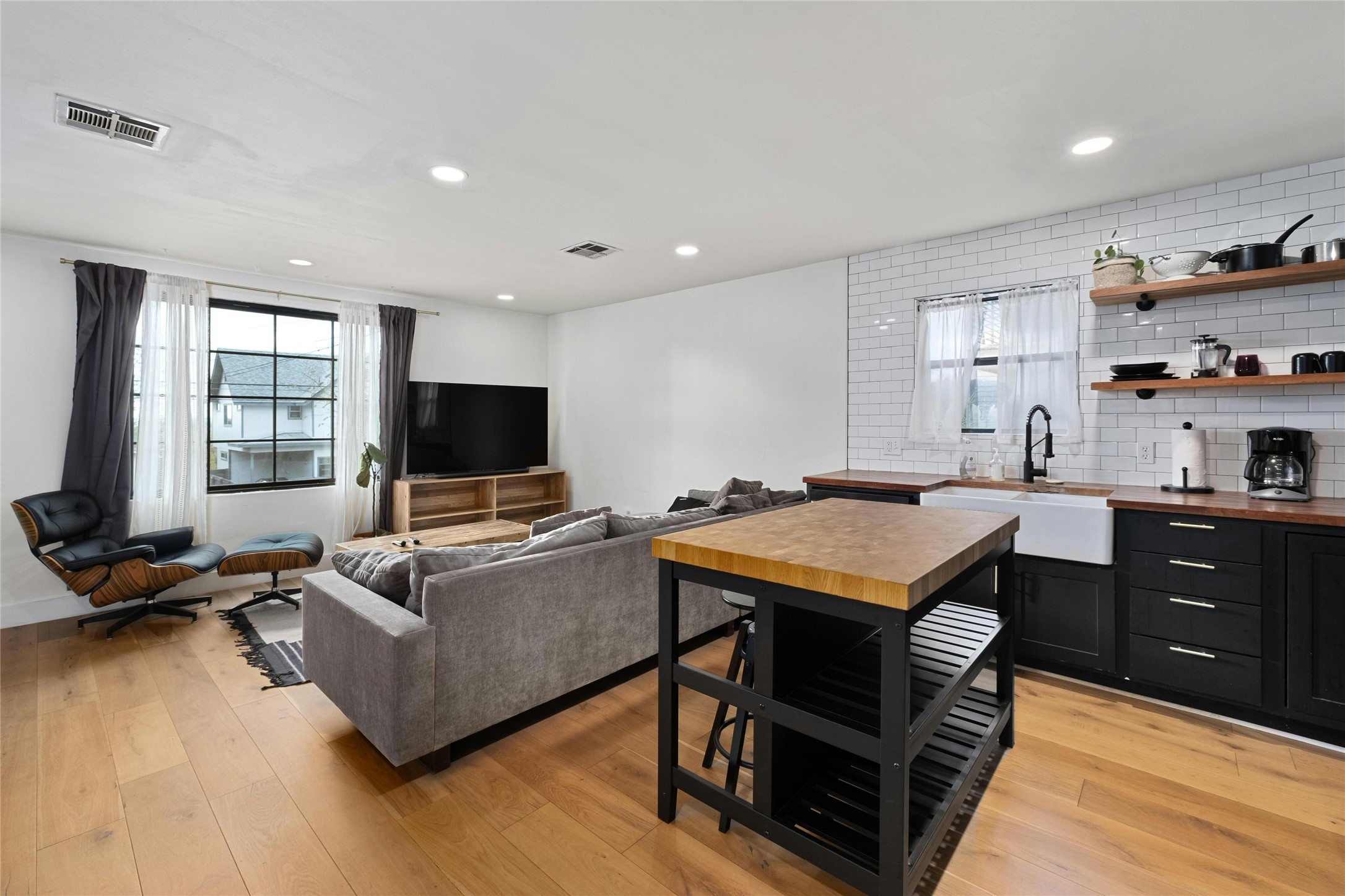 2804 Crest Avenue Austin, TX 78702 - Photo 5 of 16 a living room with furniture a flat screen tv and kitchen view