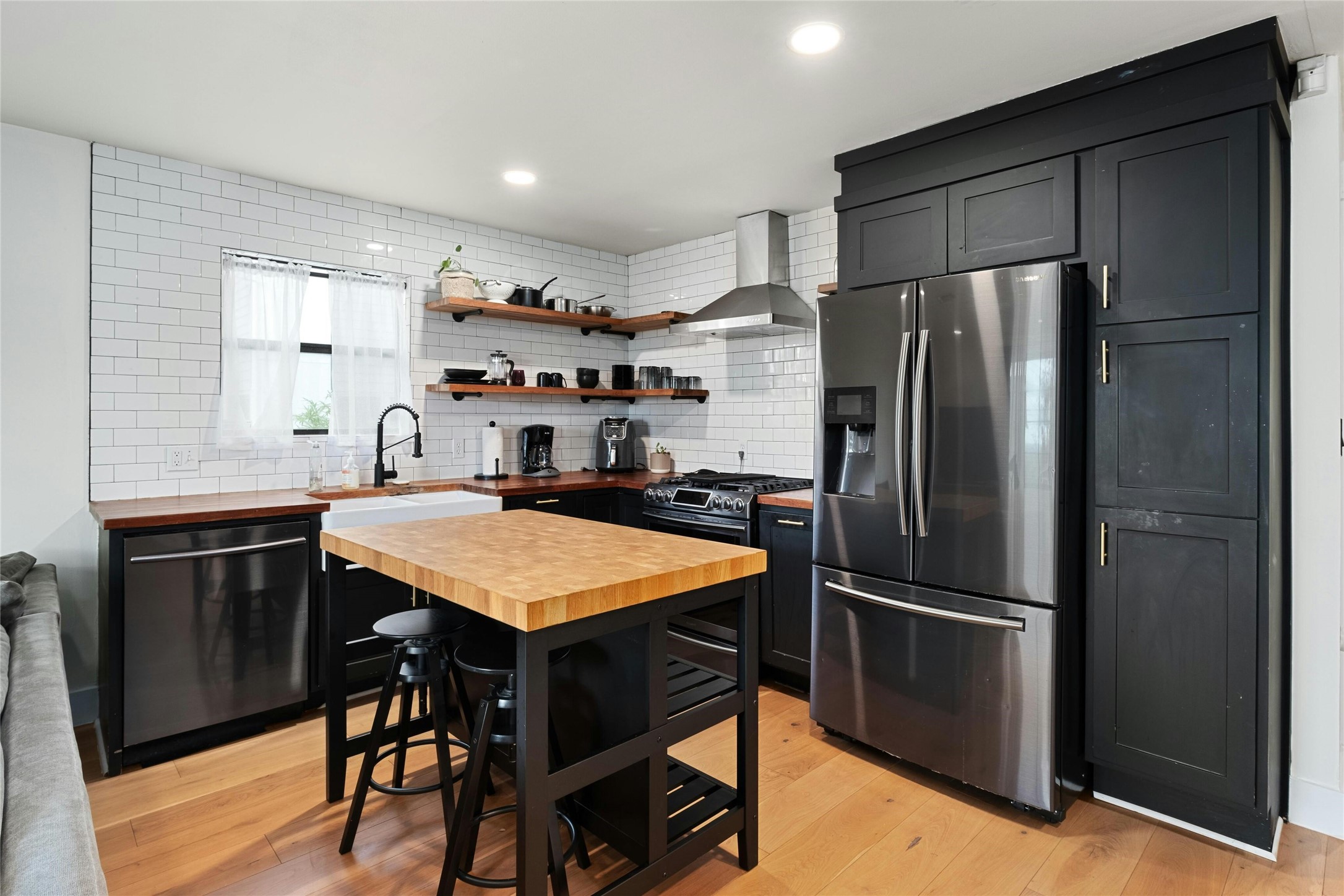 2804 Crest Avenue Austin, TX 78702 - Photo 6 of 16 a kitchen with refrigerator cabinets and wooden floor