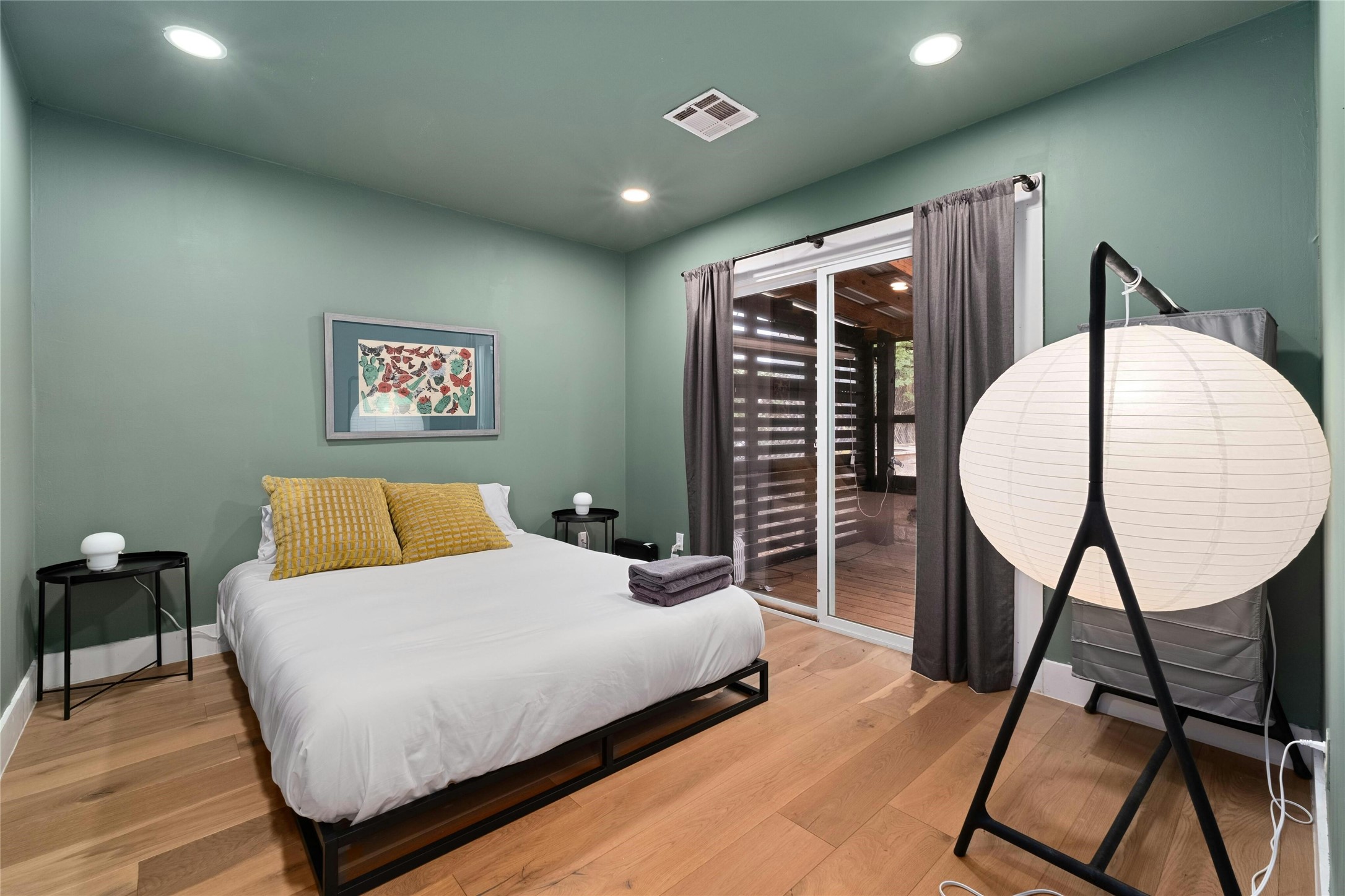 2804 Crest Avenue Austin, TX 78702 - Photo 10 of 16 a bedroom with a bed a dresser and a potted plant