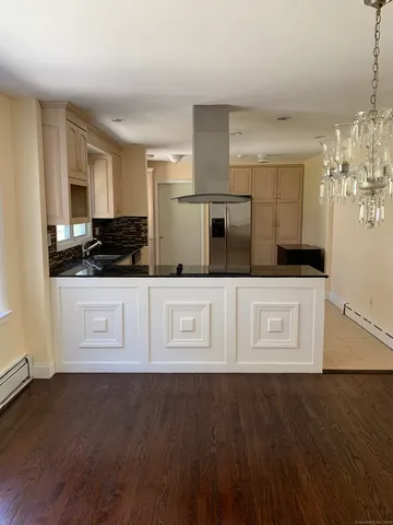 a kitchen with stainless steel appliances a white cabinet and a granite counter top