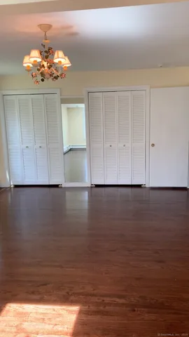 a view of a room with wooden floor and cabinet