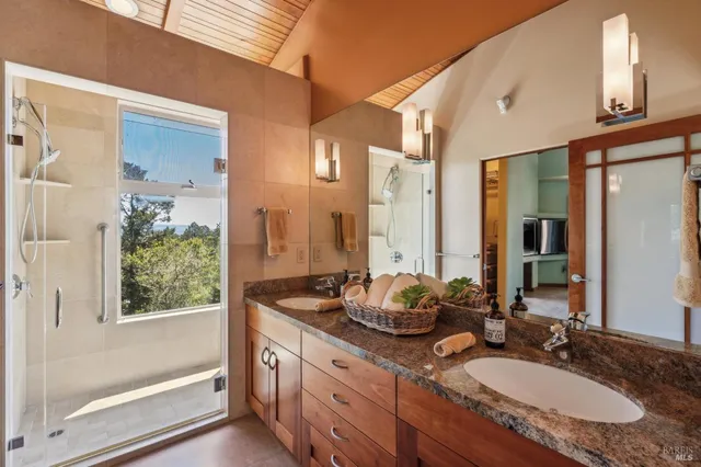 a bathroom with a granite countertop sink and a mirror