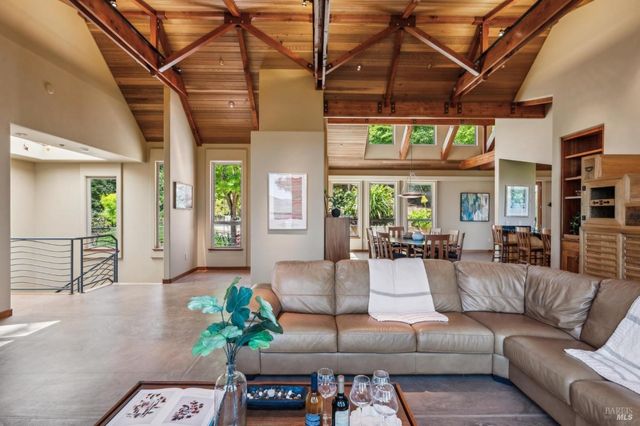 a living room with furniture a chandelier and a potted plant