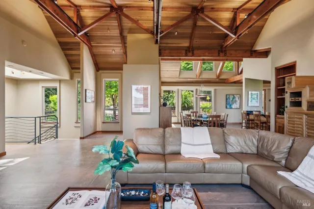 a living room with furniture a chandelier and a potted plant