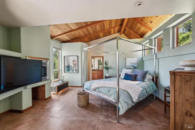 a bedroom with a bed and a flat screen tv