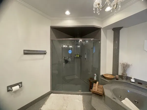 a bathroom with a granite countertop sink a shower and a mirror