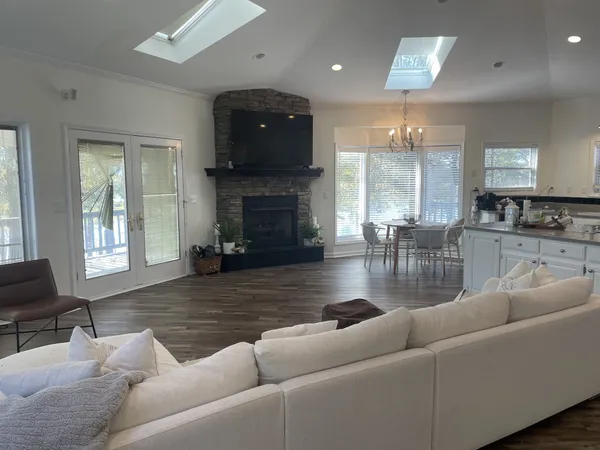 a living room with furniture a fireplace and a large window