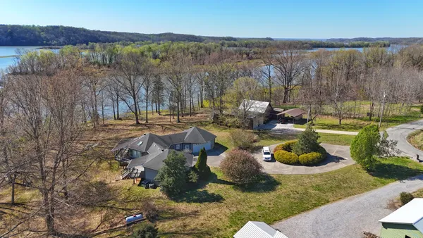 an aerial view of a house with a yard